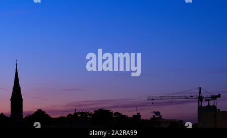 Silhouette Of Buildings In City Against Sky During Sunset Stock Photo