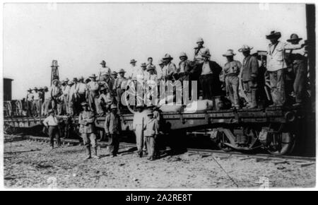 Railroad trains transporting Insurrectos during the Mexican Revolution: Soldiers standing on 2 flat cars Stock Photo