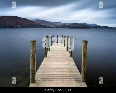 Ashness Boat Landing overlooking the mountains of the Northern Lake District on Derwent Water near Keswick, on a cool grey morning. Stock Photo