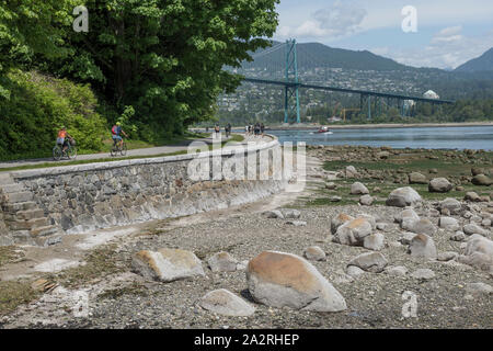 View of the Lions Gate Bridge from The Stanley Park Seawall Waterfront Path in Stanley Park, Vancouver, British Columbia, Canada. Stock Photo