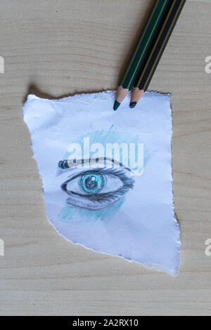 Eye drawn on a sheet of paper with colored pencils. Stock Photo