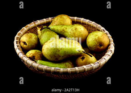 Basket of freshly picked organic pears isolated on black Stock Photo