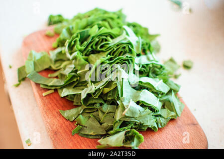 Fresh organic sorrel,plant spinach heap on wooden table for spring green vegetables soup and salad.Raw sorrel leaves top view green vegetable backgrou Stock Photo