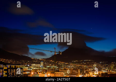 Cloud obscures the Cape Town landmark of Lion's Head that rises above the South African Atlantic port city Stock Photo