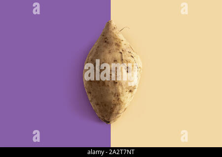 okinawan sweet potatoes on purple and light brown background Stock Photo