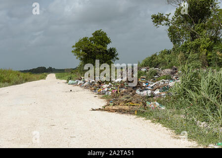 Orange Walk, Belize - May 21, 2017: Trash dumped next to road - highlights the issue of roadside garbage disposal in Latin America. Stock Photo