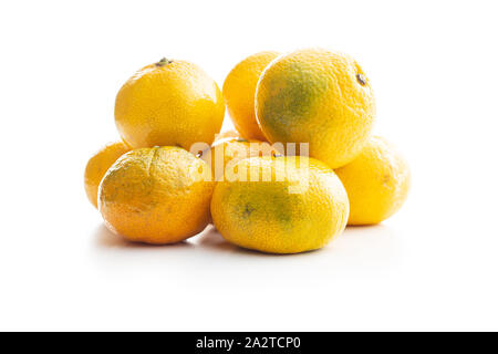 Fresh yellow tangerines isolated on white background. Stock Photo