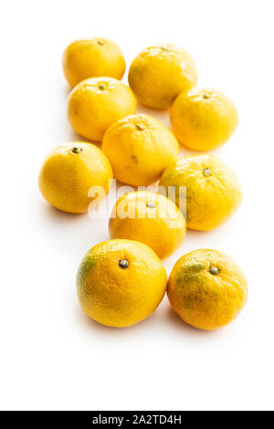 Fresh yellow tangerines isolated on white background. Stock Photo