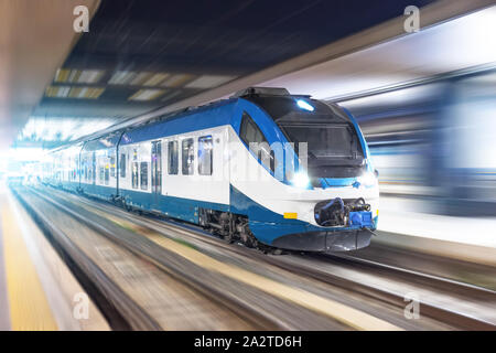 Railroad travel passenger train with motion blur effect night, industrial concept, tourism