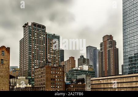 New York City, USA, May 2019, view of skyscrapers on the 11th Ave & W 45th St on an overcast day in Hell's Kitchen Stock Photo