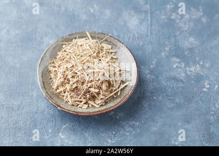 Siberian ginseng (Eleutherococcus senticosus) on rustic wooden background. Copy space. Stock Photo