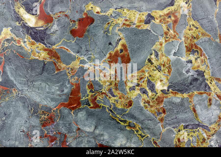 Backgrounds and textures: surface of beautiful grey decorative stone, abstract pattern of yellow and red cracks, spots and stains, natural background Stock Photo