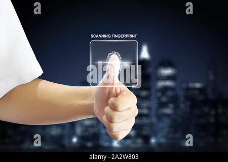 Business man using a holographic fingerprint scanner for security in blurred skyline background Stock Photo