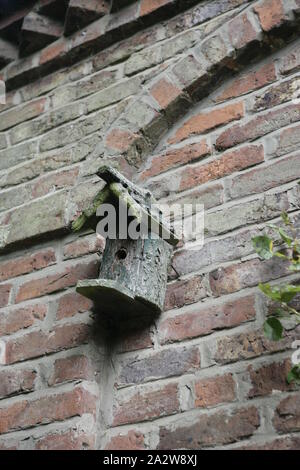 Bird Nesting Box Fixed to Old Red Brick Outbuilding Wall Stock Photo