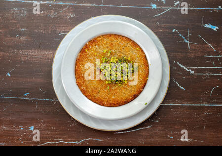 Delicious traditional Turkish dessert:  Kunefe  kadayif with pistachio and cheese Stock Photo