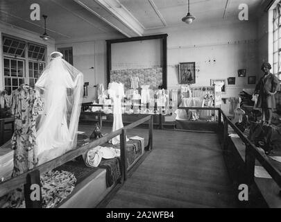 Negative - Emily McPherson College, Handcraft Display, circa 1935, Negative photograph of a display of adult and children's clothing and dolls at Emily McPherson College, Melbourne. The date is unknown, but the college opened in 1927, and clothing and imagery depicted suggests a date around the mid-1930s Stock Photo