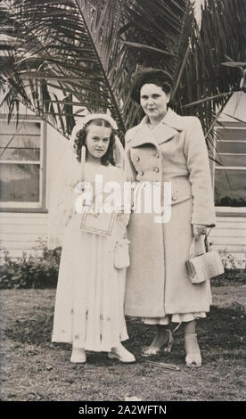 Digital Photograph - Girl Dressed for First Communion with Mother, Midway Migrant Hostel, Maribyrnong, 1950, Black and white photograph showing Irene Jerzyk preparing for her First Communion at Midway Migrant Hostel in Maribyrnong in 1950, with her mother Janina. The Jerzyk family immigrated to Australia as part of the Displaced Persons Scheme from Poland. They were Polish Catholics