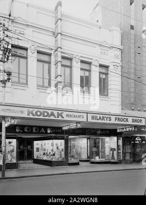 Negative, Shop Exterior, Perth, Western Australia, circa 1940s, Black and white film negative of the Kodak Australasia Pty Ltd branch store at 662 Hay Street, Perth, Western Australia, taken in the 1940s. This street view shows the Kodak shop front displays of photographs and photographic products, and the windows of neighbouring Hilary's Frock shop. collection of products, promotional materials, photographs and working life Stock Photo