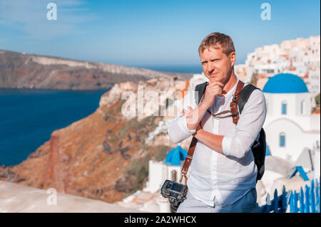 Man photographer taking pictures of Santorini, Greece. Shooting. Camera. Stock Photo