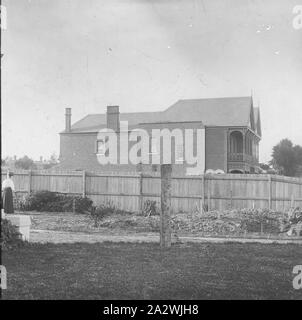 Lantern Slide - Suburban Home, Australia, Date Unknown, Black and white image looking across a newly established suburban garden to the neighbour's two storey home over the fence, photographed by A.J. Campbell Stock Photo