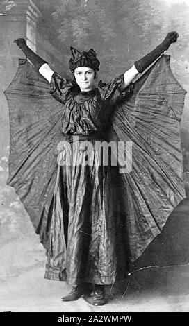 Negative - Girl Dressed as a Bat, Sydney (?), New South Wales (?), circa 1930, A girl in fancy dress, she is dressed as a bat and stands with her arms raised Stock Photo