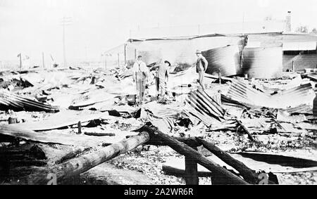Negative - Burnt out shop, Manangatang, Victoria, 1933, On the 16th of March, 1933 a fire in the town of Mananatang destroyed three shops. This image shows the remains of one of the shops, Raphael's Store. It was reported in the Sydney Morning Herald the following day that due to the anbsence of any fire fighting equipment, and the poor water supply, handicapped fire-fighters. It was estimated that the fire caused between £8000 - £10000 damage