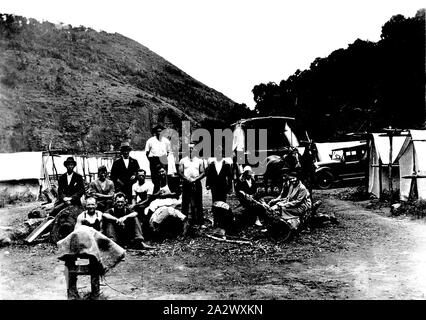 Negative - Cumberland River, Victoria, circa 1930, A group of construction workers at a road camp. There are tents, a motor car and a horse-drawn wagon on the right Stock Photo