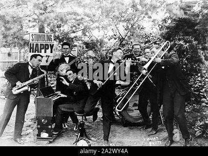 Negative - Castlemaine, Victoria, circa 1920, A jazz group performing in a garden. A sign behind them reads 'Stumbling happy ....7 Stock Photo