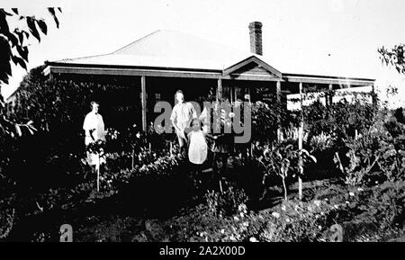 Negative - Red Cliffs, Victoria, circa 1935, Mrs Weir and family outside her home. There is an extensive garden Stock Photo