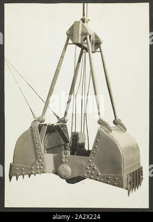 Photograph - A.T. Harman & Sons, Open Excavator Bucket, circa 1923, One of three black and white photographs attached to an album page. Part of a group of five album pages and three loose photographs depicting excavators, winches and other industrial equipment manufactured by A.T. Harman & Sons. Part of a collection of photographs, film, engineering drawings, trade literature and business papers relating to the operations of the Victorian engineering firm A.T Stock Photo