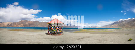 view at Pangong lake with ritual flags with prayers at Shyok valley in Ladakh, northern India Stock Photo