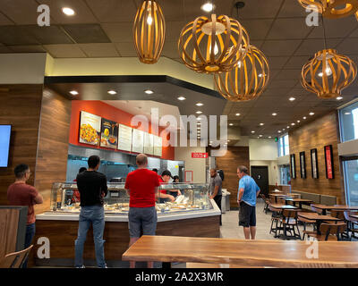 Orlando,FL/USA-10/2/19: People waiting in line at a Panda Exress restaurant to order Chinese food. Stock Photo