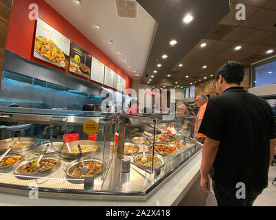 Orlando,FL/USA-10/2/19: People waiting in line at a Panda Exress restaurant to order Chinese food. Stock Photo