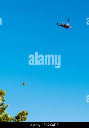 Kaman K-MAX; K-1200; helicopter with intermeshing rotors; synchropter; carrying water to fight the Decker forest fire near Salida; Colorado; USA Stock Photo