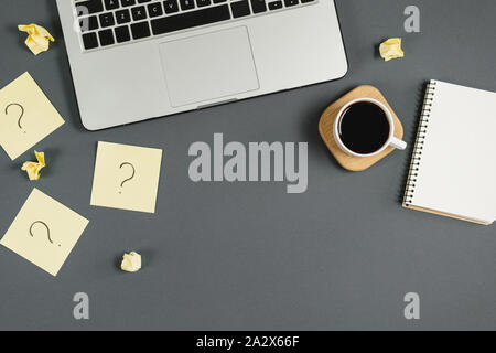 Asking, Decisions. Question mark on sticky notes, notebook, cup coffee, laptop, pen on blue background. FAQ concept. Working with clients. Troubles in Stock Photo