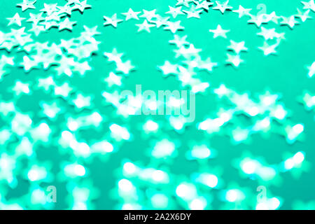 Silver star sparkles on mint backdrop. Festive Christmas concept. Stock Photo