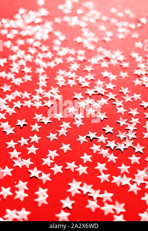 Silver star sparkles on red backdrop. Festive Christmas concept Stock Photo