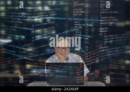 Feeling sleepy at work. Web developer falling asleep while coding. Random HTML codes overlay. Stock Photo