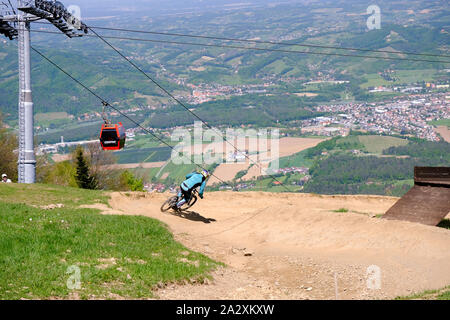 Maribor, Slovenia - May 2, 2019: Downhill mountain bikers riding down the trail on Pohorje near Maribor, Slovenia. Pohorje bike park is very popular Stock Photo