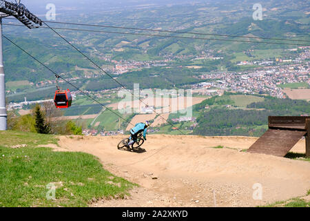 Maribor, Slovenia - May 2, 2019: Downhill mountain bikers riding down the trail on Pohorje near Maribor, Slovenia. Pohorje bike park is very popular Stock Photo