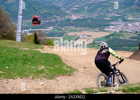 Maribor, Slovenia - May 2, 2019: Downhill mountain bikers riding down the trail on Pohorje near Maribor, Slovenia. Pohorje bike park is very popular Stock Photo