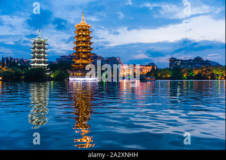 Guilin, China, 17 Jun 2014: Night view of popular tourist attraction Sun and Moon Pagodas in Guilin. Stock Photo