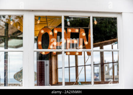 Sign that store is open made from an application of letters with mounted bulbs and displayed in the window of a provincial store to inform buyers and Stock Photo