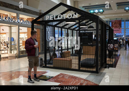 A shopper looks at a Peloton showroom from outside in Washington Square Shopping Mall in Tigard, Oregon, on Sunday, Sep 29, 2019. Stock Photo