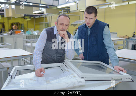production workers with different pvc window Stock Photo