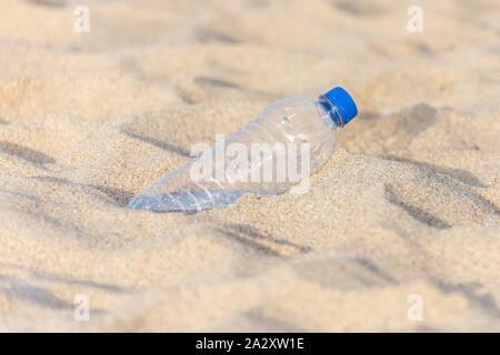 Plastic bottle on the beach sand, left by tourist Stock Photo