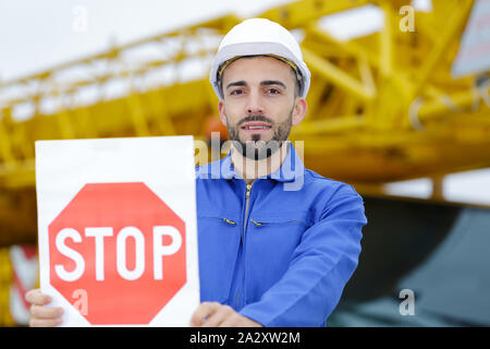 tradesman holding a stop sign Stock Photo