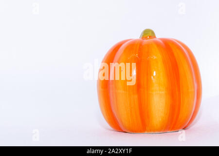Bright orange festive pumpkin ornament on an isolated white background for fall thanksgiving and halloween season. Stock Photo