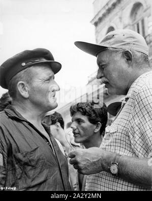 SPENCER TRACY and ERNEST HEMINGWAY on set Cuba location candid filming THE OLD MAN AND THE SEA 1958 director Fred Zinnemann and John Sturges novel ERNEST HEMINGWAY screenplay Peter Viertel  Leland Hayward Productions / Warner Bros. Stock Photo