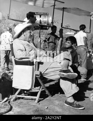 SPENCER TRACY and FELIPE PAZOS on set location candid filming THE OLD MAN AND THE SEA 1958 director Fred Zinnemann and John Sturges novel ERNEST HEMINGWAY screenplay Peter Viertel  Leland Hayward Productions / Warner Bros. Stock Photo
